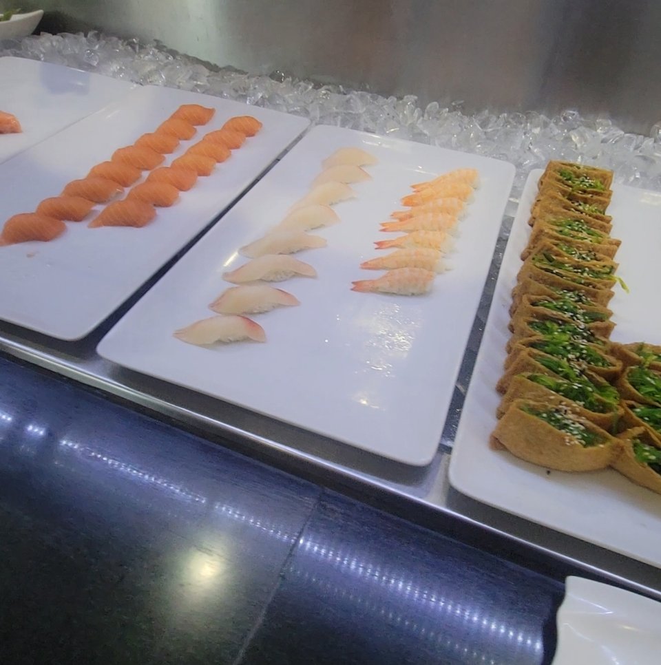 Takeout containers beside seafood and sushi